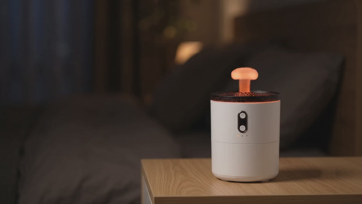 Volcano Mist Diffuser blowing glowing mist rings on a bedside table